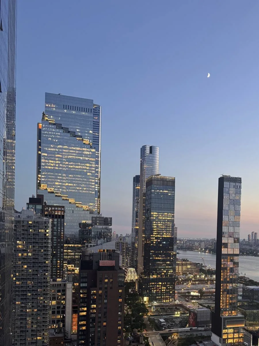 Hudson Yards towers at dusk with a crescent moon, seen from 41st and 10th Ave